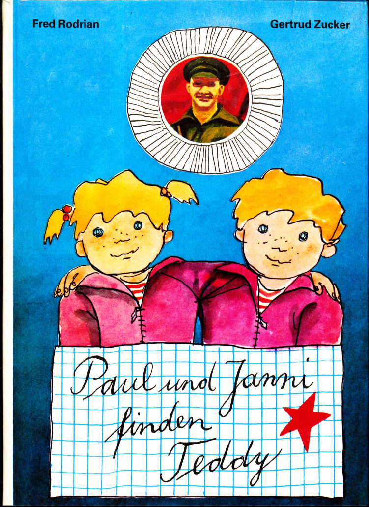 Cover von "Paul und Janny finden Teddy". Der Titel steht auf einem karierten Blatt Papier, neben der Schrift ist ein roter Stern. Zwei Kinder, die sich nur durch ihre Frisuren unterscheiden, halten einander im Arm. Ganz oben auf dem Cover ist ein rundes Porträt von Ernst Thälmann.
